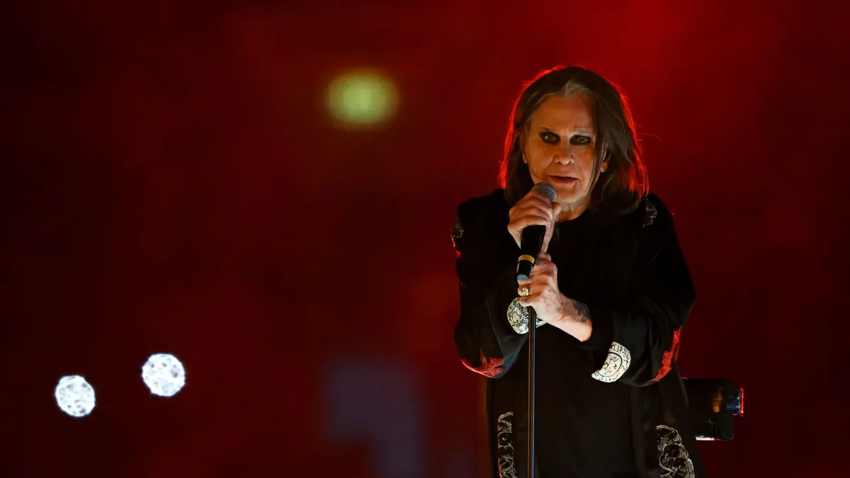 (FILES) British singer Ozzy Osbourne performs during the closing ceremony for the Commonwealth Games at the Alexander Stadium in Birmingham, central England, on August 8, 2022. Ozzy Osbourne, the frontman of heavy metal group Black Sabbath, died on July 22, 2025 at the age of 76, his family announced in a statement. "He was with his family and surrounded by love. We ask everyone to respect our family privacy at this time," the statement added. (Photo by Andy Buchanan / AFP)