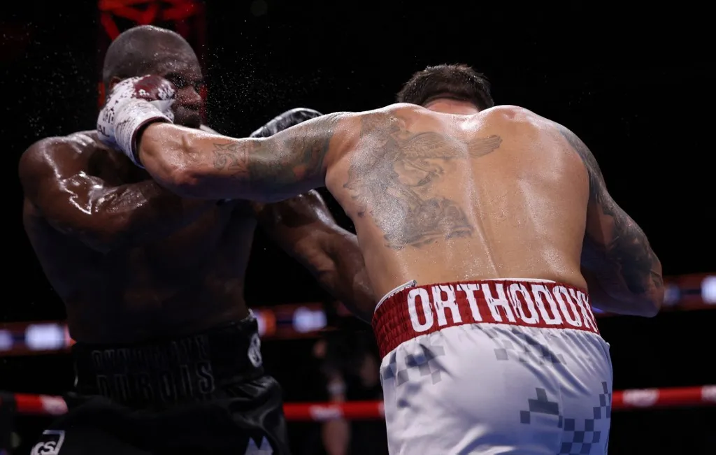 uszik Ukraine's Oleksandr Usyk (R) and Britain's Daniel Dubois fight during their undisputed world heavyweight boxing title bout at Wembley Stadium in London on July 19, 2025. (Photo by Adrian Dennis / AFP)
