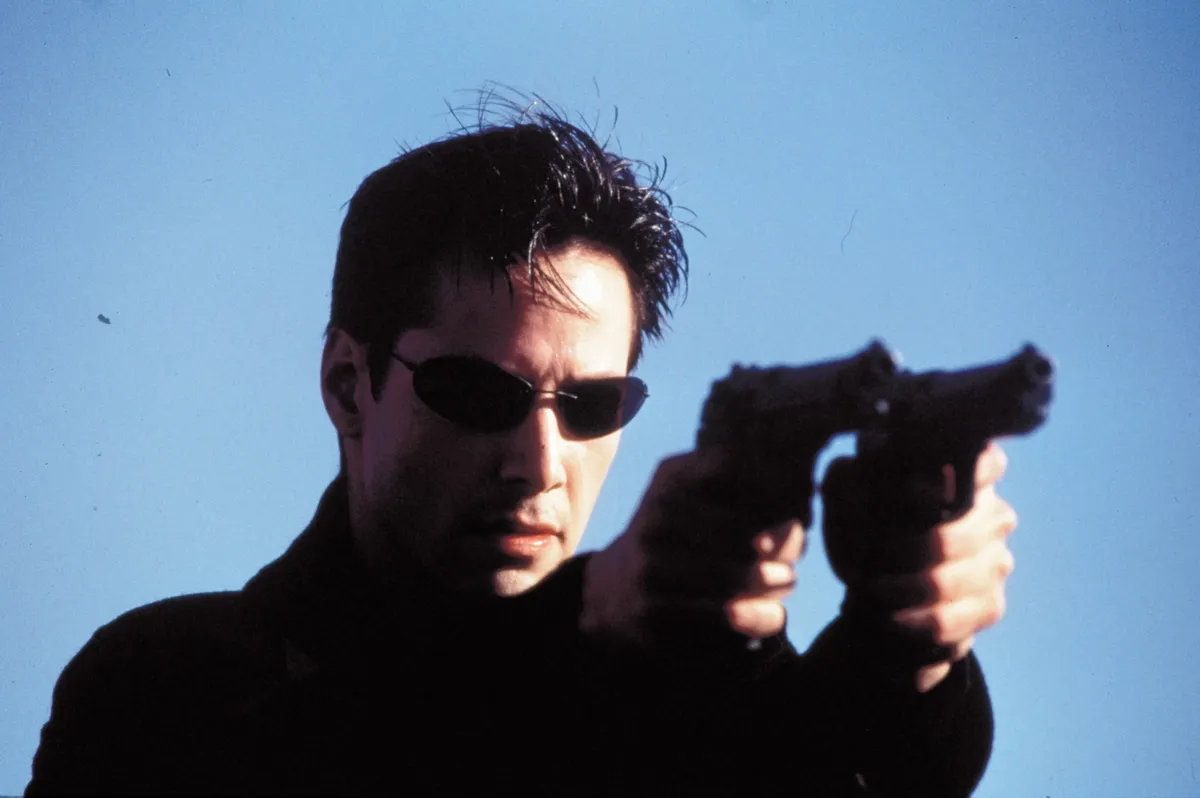 Keanu Reeves, 1999; The Matrix. Original Film Title: The Matrix, PICTURED: KEANU REEVES, Composer: Don Davis, Director: Larry Wachowski, IN CAST: Keanu Reeves, Laurence Fishburne, Carrie-Anne Moss, Joe Pantoliano, Hugo Weaving, Gloria Foster, Marcus Chong, Paul Goddard, Robert Taylor, Julian Arahanga, Matt Doran, Belinda Mcclory, Anthony Ray Parker 