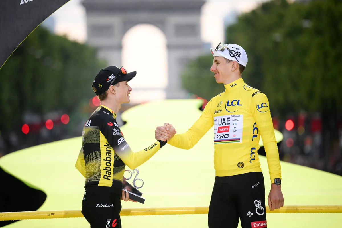 Danish Jonas Vingegaard Hansen of Team Visma-Lease a Bike and Slovenian Tadej Pogacar of UAE Team Emirates pictured on the podium after stage 21 of the 2025 Tour de France cycling race, from Mantes-la-Ville to Paris (120km), on Sunday 27 July 2025 in France. The 112th edition of the Tour de France starts on Saturday 5 July in Lille, France, and will finish in Paris, France on the 27th of July. BELGA PHOTO POOL BERNARD PAPON (Photo by POOL BERNARD PAPON / BELGA MAG / Belga via AFP)