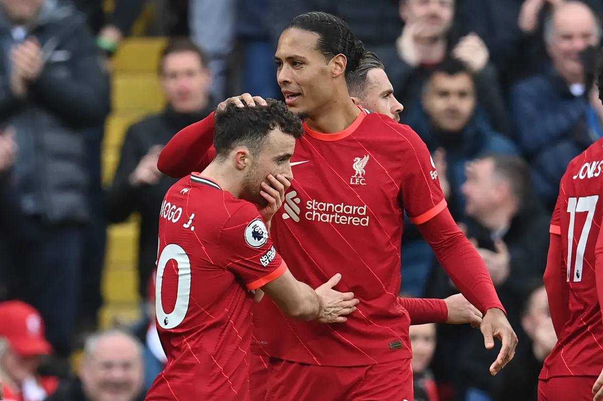 Liverpool's Portuguese striker Diogo Jota (L) celebrates with Liverpool's Dutch defender Virgil van Dijk after scoring the opening goal of the English Premier League football match between Liverpool and Watford at Anfield in Liverpool, north west England on April 2, 2022. (Photo by Paul ELLIS / AFP) / RESTRICTED TO EDITORIAL USE. No use with unauthorized audio, video, data, fixture lists, club/league logos or 'live' services. Online in-match use limited to 120 images. An additional 40 images may be used in extra time. No video emulation. Social media in-match use limited to 120 images. An additional 40 images may be used in extra time. No use in betting publications, games or single club/league/player publications. / 
