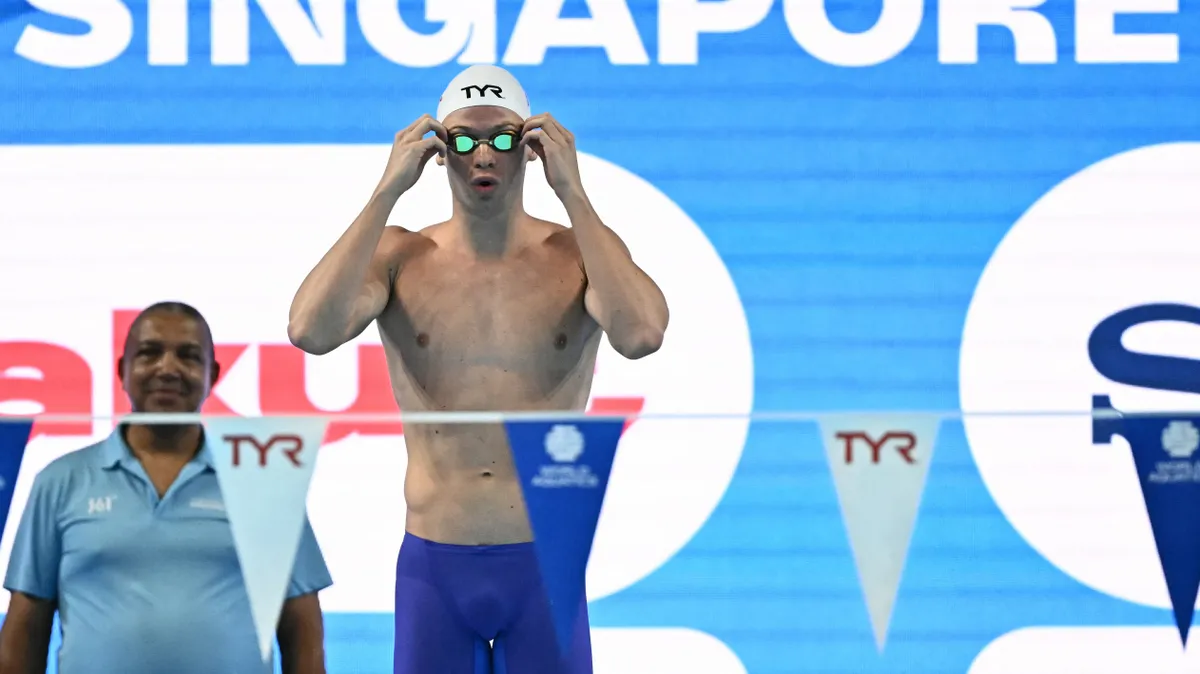 Milák Kristóf, France's swimmer Leon Marchand prepares for the start of a semi-final of the men's 200m individual medley swimming event during the 2025 World Aquatics Championships in Singapore on July 30, 2025. (Photo by MANAN VATSYAYANA / AFP)