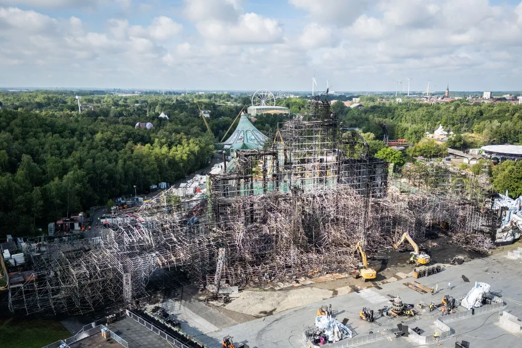 This aerial photograph shows the main stage of the Tomorrowland music festival that was totally destroyed by fire a day before thousands of electronic dance music lovers were due to descend on the Belgian event in Boom, near Antwerp, on July 17, 2025. There were no injuries, organisers said, insisting that they would still go ahead with the festival over the next two weekends. (Photo by Belga / AFP) / Belgium OUT