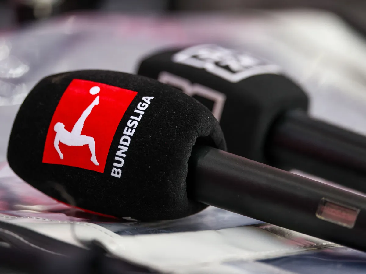 Bundesliga, 12 January 2025, Saxony, Leipzig: Soccer: Bundesliga, RB Leipzig - Werder Bremen, Matchday 16, Red Bull Arena. Microphones with the Bundesliga and DAZN logos are on a box. Photo: Jan Woitas/dpa - IMPORTANT NOTE: In accordance with the regulations of the DFL German Football League and the DFB German Football Association, it is prohibited to utilize or have utilized photographs taken in the stadium and/or of the match in the form of sequential images and/or video-like photo series. (Photo by JAN WOITAS / dpa Picture-Alliance via AFP)