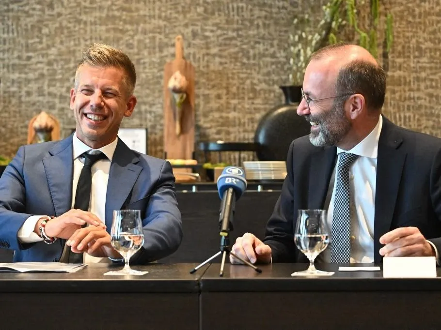 Leader of Hungarian Tisza party and former government member turned opposition leader Peter Magyar (L) and President of the centre-right European People's Party (EPP) Manfred Weber react during a meeting with local press in a Budapest's hotel Hungary on June 14, 2024. Weber arrived to Budapest about the accession of the seven elected members of the European Parliament of the Tisza party. (Photo by Attila KISBENEDEK / AFP)