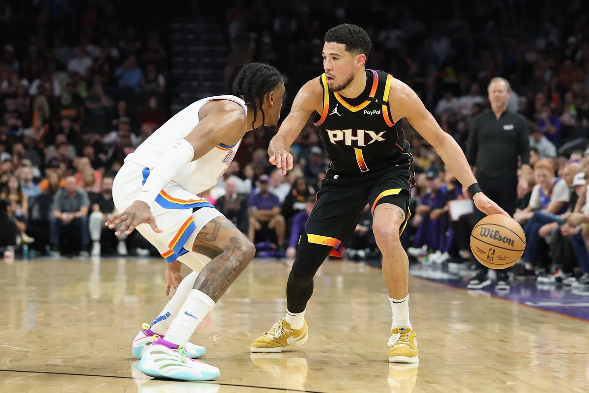 PHOENIX, ARIZONA - APRIL 09: Devin Booker #1 of the Phoenix Suns handles the ball against Jalen Williams #8 of the Oklahoma City Thunder during the second half of the NBA game at PHX Arena on April 09, 2025 in Phoenix, Arizona. NOTE TO USER: User expressly acknowledges and agrees that, by downloading and or using this photograph, User is consenting to the terms and conditions of the Getty Images License Agreement.   Christian Petersen/Getty Images/AFP (Photo by Christian Petersen / GETTY IMAGES NORTH AMERICA / Getty Images via AFP)