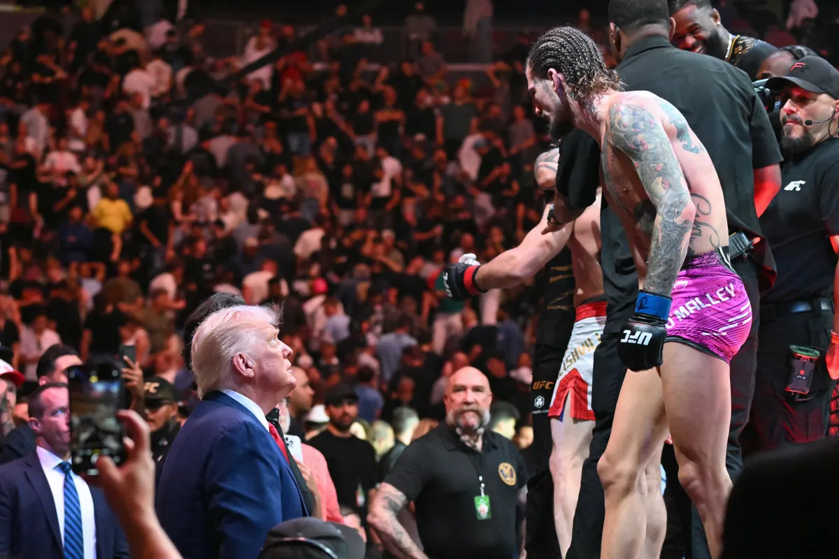 US President Donald Trump (L) talks to US mixed martial artist Sean O'Malley (R) after he lost against unseen Georgian mixed martial artist Merab Dvalishvili during a UFC 316 event, at the Prudential Center in Newark, New Jersey on June 7, 2025. (Photo by ANDREW CABALLERO-REYNOLDS / AFP)