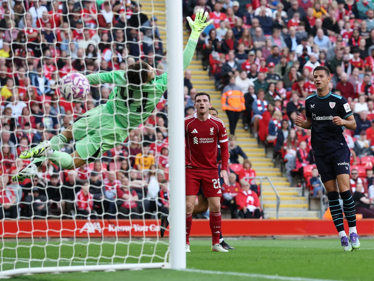 Athletic Bilbao's Spanish striker #12 Gorka Guruzeta (R) scores the team's first goal past Liverpool's Hungarian goalkeeper #41 Armin Pecsi (L) during the first of two pre season friendly football matches between Liverpool and Athletic Bilbao at Anfield in Liverpool, north west England on August 4, 2025. (Photo by Darren Staples / AFP)