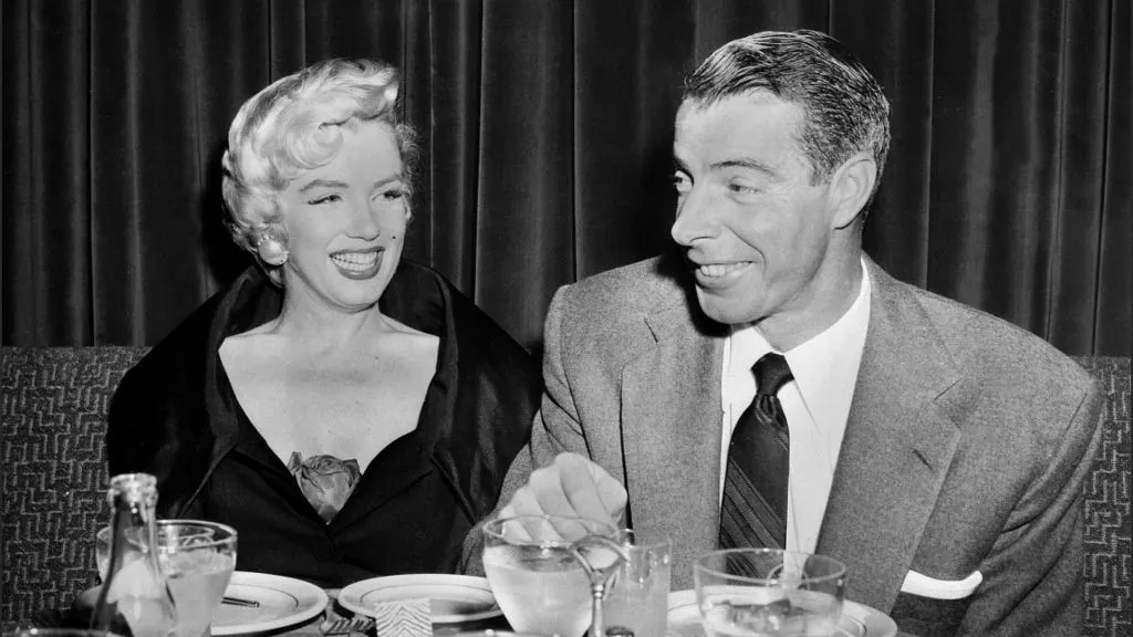 Picture dated of the fifties showing American actress Marilyn Monroe (L) with her husband baseball legend Joe DiMaggio. (Photo by AFP)