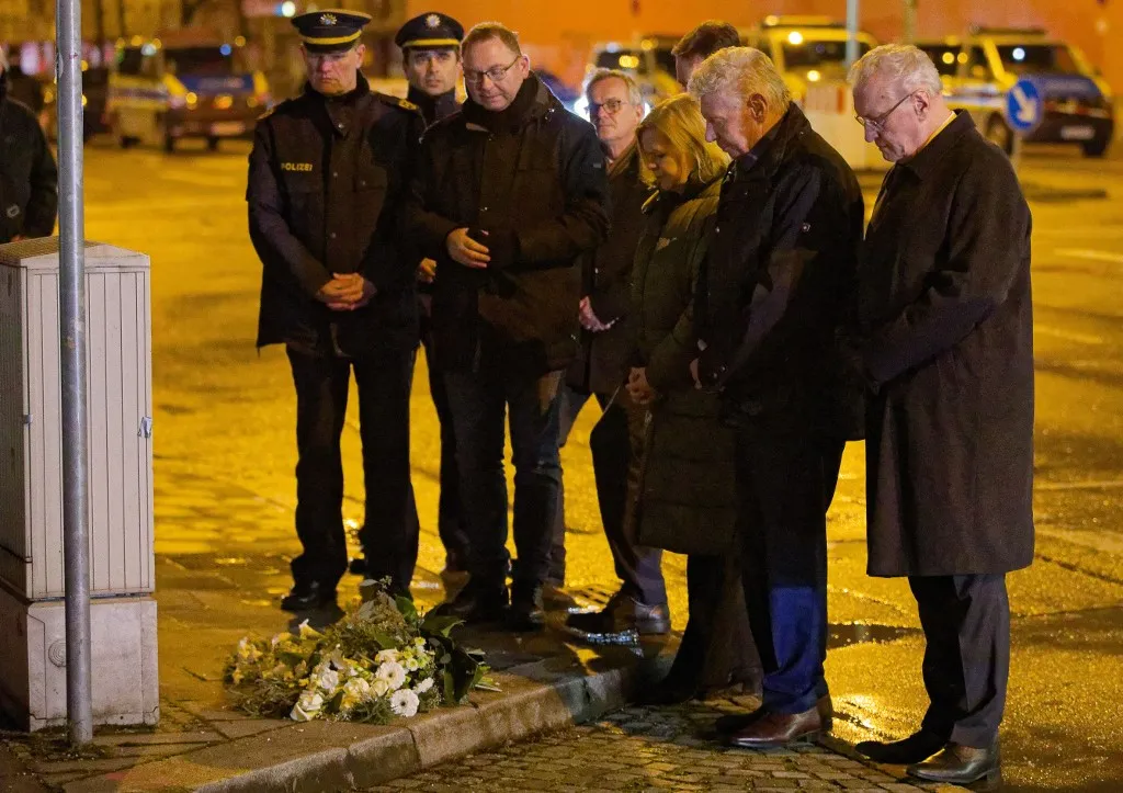 13 February 2025, Bavaria, Munich: Frank Werneke (3rd from left), Chairman of the United Services Union (ver.di), Nancy Faeser (SPD, 3rd from right), Federal Minister of the Interior, Dieter Reiter (SPD, 2nd from right), Lord Mayor of Munich, and Joachim Herrmann (CSU, right), Bavarian Minister of the Interior, lay a wreath at the spot where a car drove into a demonstration. Several people were injured, some of them seriously. Photo: Tizian Gerbing/dpa (Photo by Tizian Gerbing / dpa Picture-Alliance via AFP)
