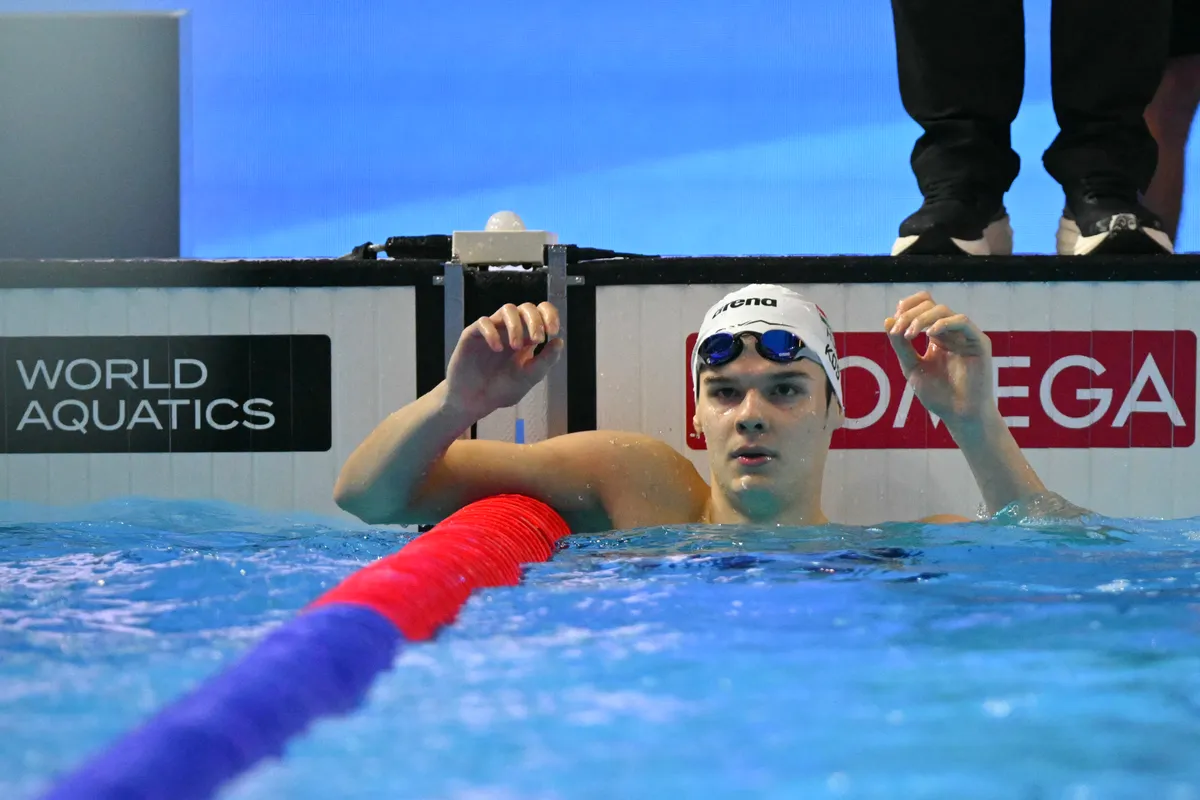 Hungary's swimmer Hubert Kos reacts after the final of the men's 200m backstroke swimming event during the 2025 World Aquatics Championships in Singapore on August 1, 2025. (Photo by François-Xavier MARIT / AFP) Kós Hubert