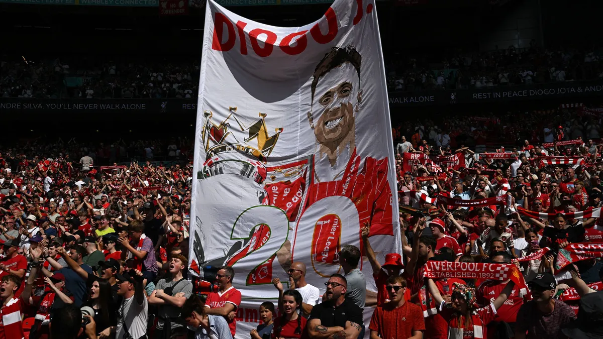 Liverpool fans display a banner to pay tribute to Liverpool's Portuguese forward Diogo Jota ahead of the English FA Community Shield football match between Crystal Palace and Liverpool at Wembley Stadium, in London on August 10, 2025. (Photo by Glyn KIRK / AFP) / NOT FOR MARKETING OR ADVERTISING USE / RESTRICTED TO EDITORIAL USE