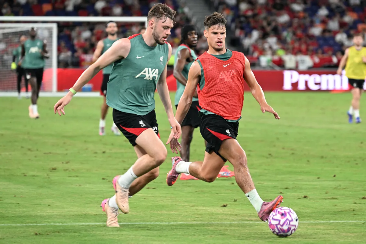 Liverpool's Hungarian midfielder Milos Kerkez (R) and Liverpool's Northern Irish defender Conor Bradley take part in a training session at the Kai Tak Stadium in Hong Kong on July 24, 2025, ahead of a friendly exhibition football match against AC Milan which will be played on July 26. (Photo by Peter PARKS / AFP)