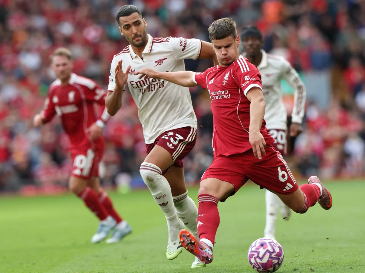 Liverpool's Hungarian defender #06 Milos Kerkez (R) plays the ball under pressure from Arsenal's Spanish midfielder #23 Mikel Merino (L) during the English Premier League football match between Liverpool and Arsenal at Anfield in Liverpool, north west England on August 31, 2025. (Photo by Darren Staples / AFP) / RESTRICTED TO EDITORIAL USE. No use with unauthorized audio, video, data, fixture lists, club/league logos or 'live' services. Online in-match use limited to 120 images. An additional 40 images may be used in extra time. No video emulation. Social media in-match use limited to 120 images. An additional 40 images may be used in extra time. No use in betting publications, games or single club/league/player publications. /