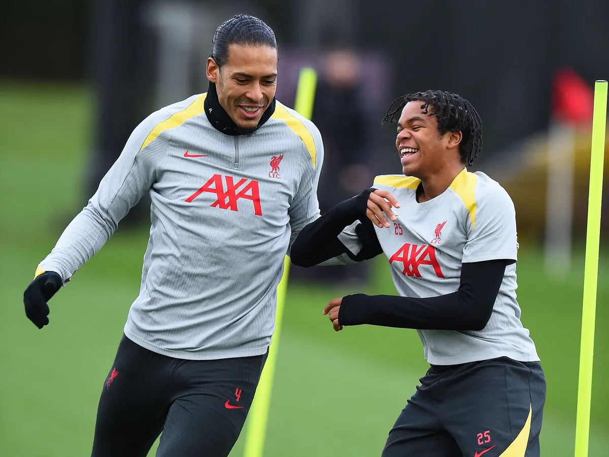 Liverpool's Dutch defender #04 Virgil van Dijk (L) and Liverpool's English striker Rio Ngumoha take part in a training session at the AXA training centre in Liverpool, north west England, on December 9, 2024, on the eve of their UEFA Champions League football match against Girona. (Photo by Peter POWELL / AFP)