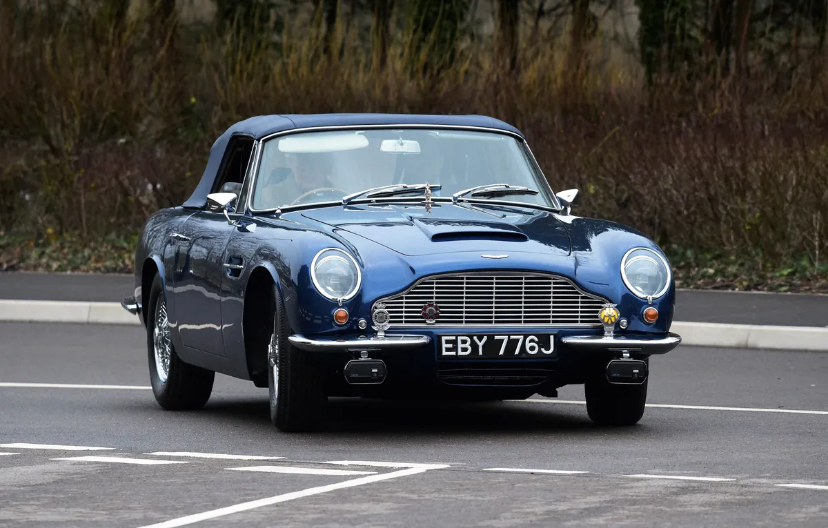 Britain's Prince Charles, Prince of Wales drives his Aston Martin DB6 as he arrives for a visit to the new Aston Martin Lagonda factory in Barry, Wales on February 21, 2020. (Photo by REBECCA NADEN / POOL / AFP)