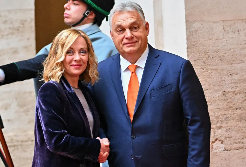 Italy's Prime Minister Giorgia Meloni (L) shakes hands with Hungarian Prime Minister Viktor Orban prior to their meeting, at Palazzo Chigi in Rome on December 4, 2024. (Photo by Andreas SOLARO / AFP)