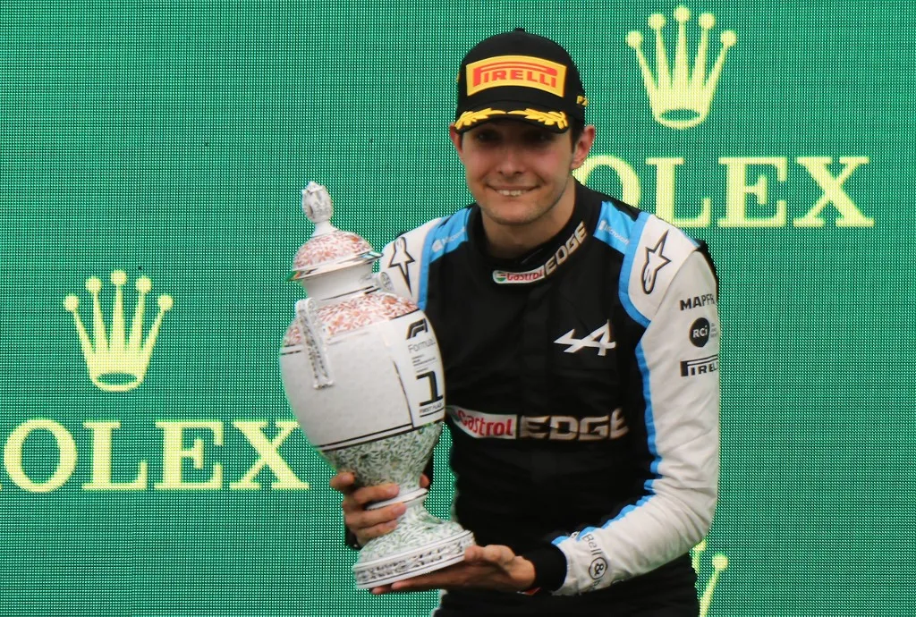 Winner Alpine's French driver Esteban Ocon celebrates on the podium after the Formula One Hungarian Grand Prix at the Hungaroring race track in Mogyorod near Budapest on August 1, 2021. (Photo by Peter Kohalmi / AFP)