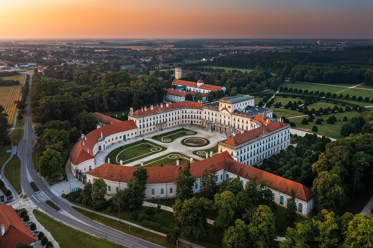 Fertod, Hungary - Aerial view of the beautiful Esterhazy Castle (Esterhazy-kastely) and garden in the Town of Fertod, near Sopron on a sunny summer morning with golden sky at sunrise