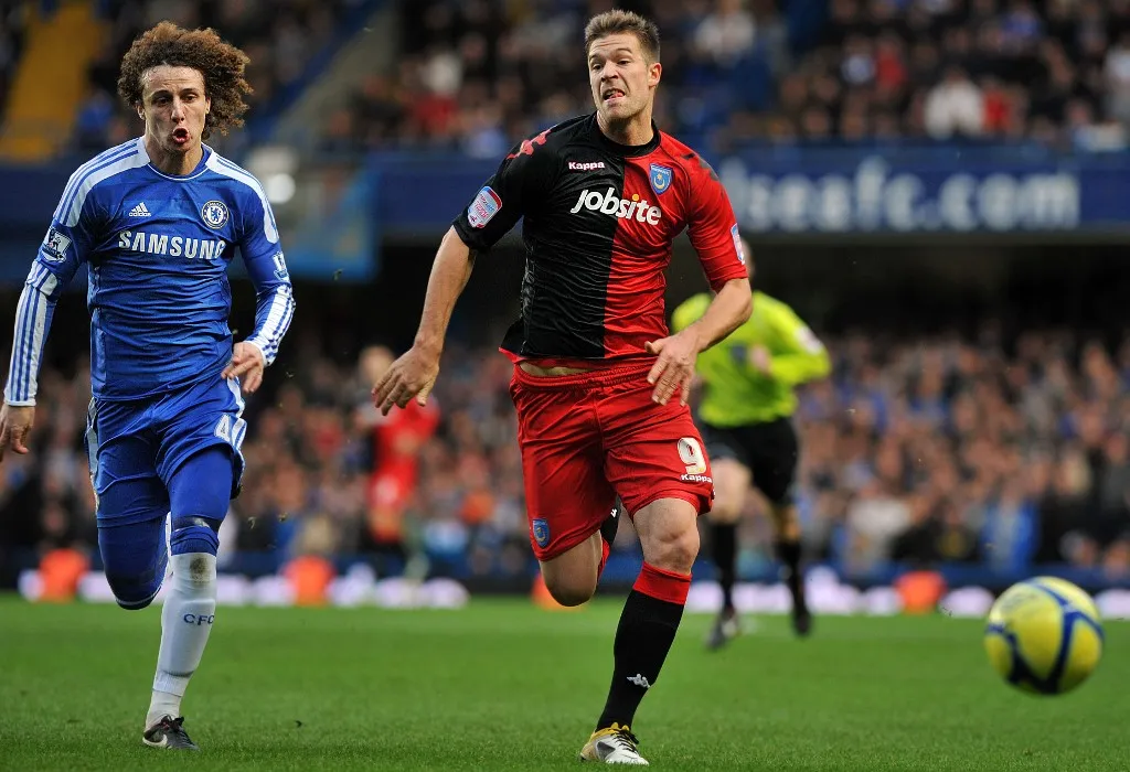 Chelsea's Brazilian defender David Luiz (L) chases the ball with Portsmouth's Hungarian striker Marko Futacs (R) during the English FA Cup third round football match between Chelsea and Portsmouth at Stamford Bridge in London on January 8, 2012. AFP PHOTO / BEN STANSALL
RESTRICTED TO EDITORIAL USE. No use with unauthorized audio, video, data, fixture lists, club/league logos or live services. Online in-match use limited to 45 images, no video emulation. No use in betting, games or single club/league/player publications. (Photo by BEN STANSALL / AFP)