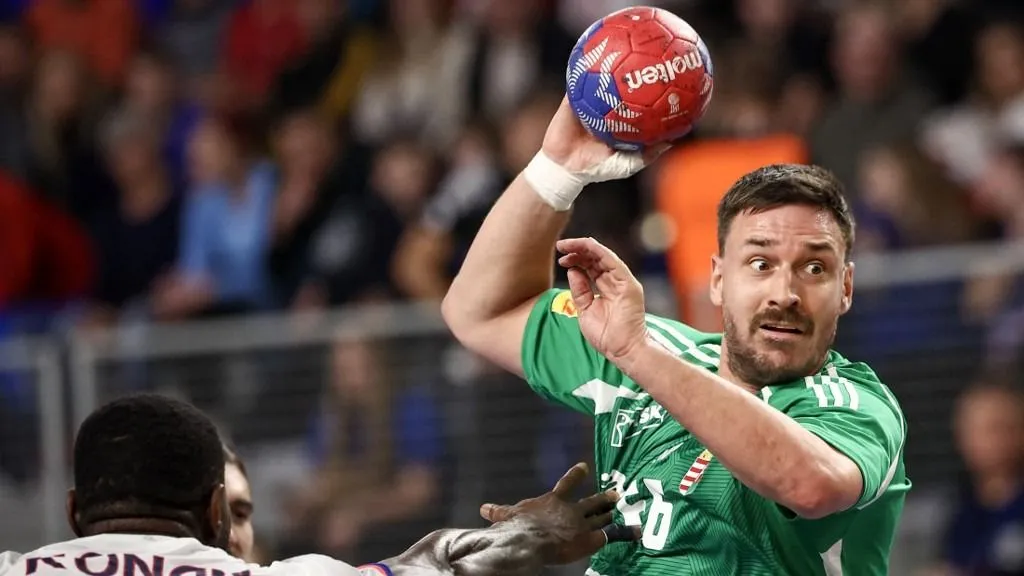 Hungary's centre back #66 Mate Lekai (R) and France's pivot #34 Karl Konan (L) vie during the Main Round Group II match between Hungary and France in the IHF Men's Handball World Championship in Varazdin, Croatia on January 21, 2025. (Photo by Anne-Christine POUJOULAT / AFP)