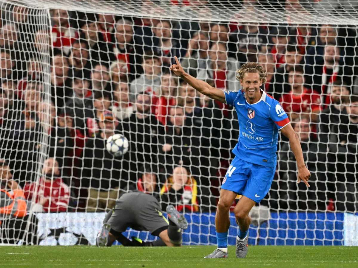 Atletico Madrid's Spanish midfielder #14 Marcos Llorente celebrates scoring his team's first goal during the UEFA Champions League first round football match between Liverpool and Atletico Madrid at Anfield in Liverpool, north west England on September 17, 2025. (Photo by Oli SCARFF / AFP)