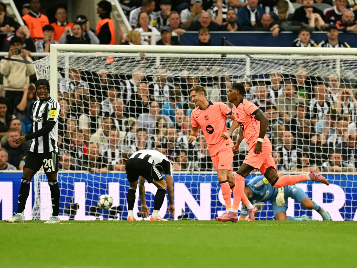 Barcelona's British forward #14 Marcus Rashford (R) celebrates after scoring his team's first goal during the UEFA Champions League first round football match between Newcastle United FC and FC Barcelona at St James' Park in London, on September 18, 2025. (Photo by Oli SCARFF / AFP)