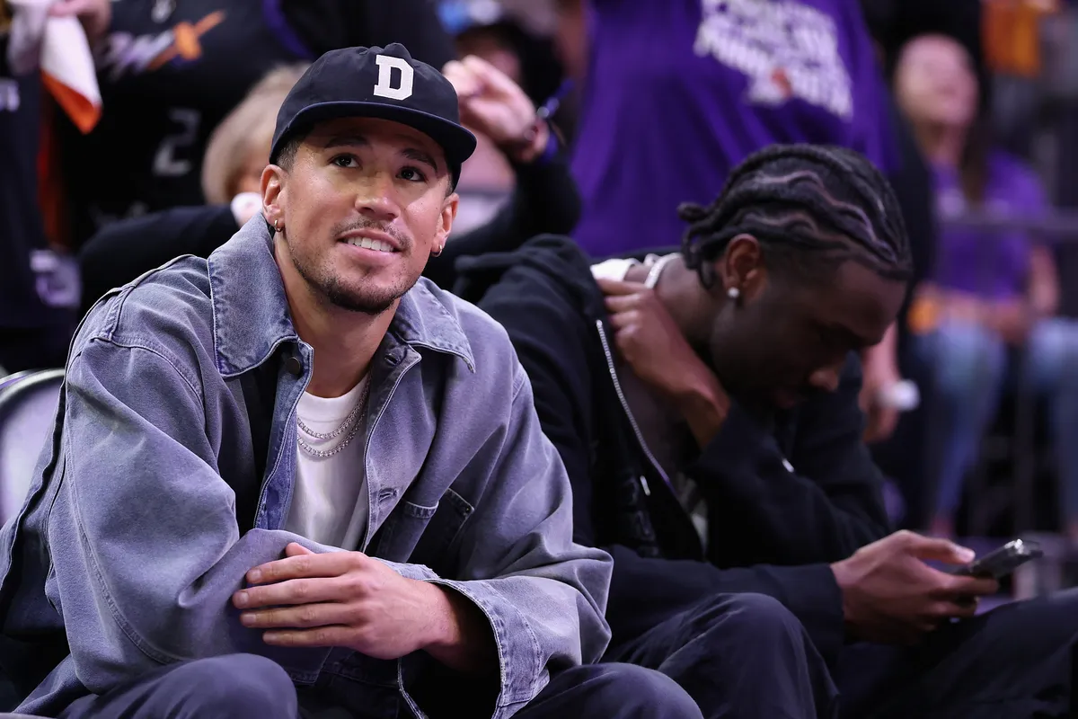 PHOENIX, ARIZONA - SEPTEMBER 28: Phoenix Suns guard, Devin Booker attends Game Four of the 2025 WNBA Playoffs semifinals between the Phoenix Mercury and the Minnesota Lynx at PHX Arena on September 28, 2025 in Phoenix, Arizona. The Mercury defeated the Lynx 86-81 to advance to the WNBA finals. NOTE TO USER: User expressly acknowledges and agrees that, by downloading and or using this photograph, User is consenting to the terms and conditions of the Getty Images License Agreement.   Christian Petersen/Getty Images/AFP (Photo by Christian Petersen / GETTY IMAGES NORTH AMERICA / Getty Images via AFP)