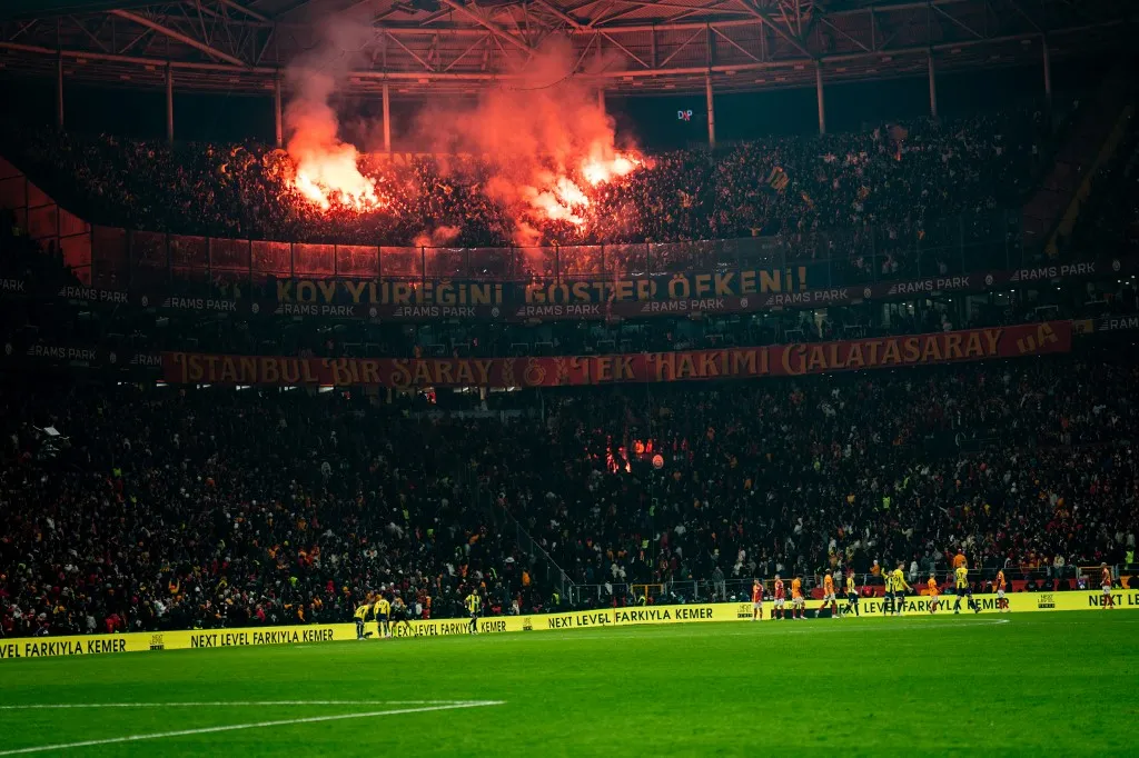 Fenerbahce fans lights up the torches during the Turkish Super League match between Galatasaray and Fenerbahce at Rams Park Stadium on February 24, 2025 in Istanbul, Turkey. (Photo by Yagiz Gurtug / Middle East Images via AFP)