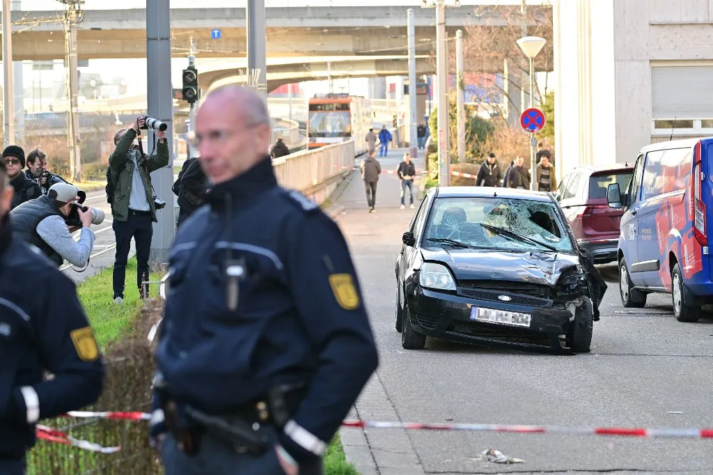 Police have cordoned off the scene of car ramming attack in Mannheim, southwestern Germany on March 3, 2025. A car driven into a crowd in southwest Germany on Monday killed two people, authorities said, adding they had arrested a 40-year-old German man after the incident. (Photo by Thomas LOHNES / AFP)