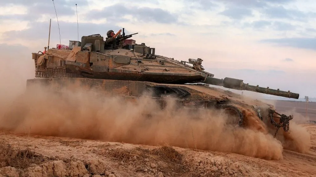 Moldova, An Israeli army soldier gestures from the turret of a Merkava main battle tank moving at a position along the border fence with the Gaza Strip in southern Israel on September 12, 2025. Israel's military said on September 9 that it will act with "great force" in Gaza City and told residents to leave as it stepped up a deadly assault on the Palestinian territory's largest urban centre. (Photo by Jack GUEZ / AFP)
