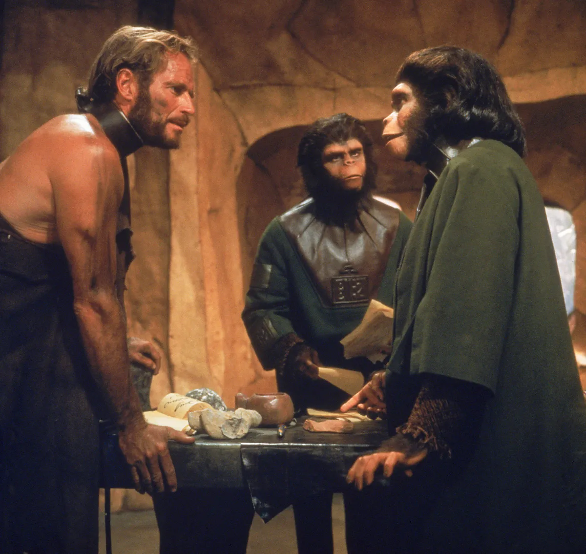 RELEASED DATE: Feb 08, 1968. MOVIE TITLE: Planet of the Apes. STUDIO: 20th Century Fox. PLOT: Taylor and two other astronauts come out of deep hibernation to find that their ship has crashed. Escaping with little more than clothes they find that they have landed on a planet where men are pre-lingual and uncivilized while apes have learned speech and technology. Taylor is captured and taken to the city of the apes after damaging his throat so that he is silent and cannot communicate with the apes. PICTURED: CHARLTON HESTON as George Taylor and KIM HUNTER as Zira. 