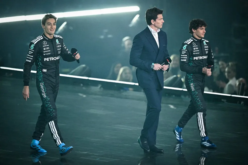 (From L) Mercedes' British driver George Russell, Mercedes' Austrian team principal Toto Wolff, Mercedes' Italian driver Andrea Kimi Antonelli arrive on stage to present the new Formula 1 car of Mercedes Formula One Team during the Formula One - 2025 season launch F1 75 LIVE event at the O2, in London, on February 18, 2025.  (Photo by Ben STANSALL / AFP) / --- RESTRICTED TO EDITORIAL USE ---