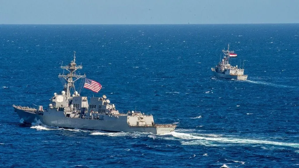 A handout picture released by the US Naval Forces Central Command/US 5th Fleet on February 7, 2022 shows US Navy guided-missile destroyer USS Jason Dunham (DDG 109) (L) and Egyptian Navy frigate ENS Alexandria (F911) conducting maneuvering-operation exercises in the Red Sea during the International Maritime Exercise/Cutlass Express. IMX/Cutlass Express 2022 is the largest multinational training event in the Middle East, involving more than 60 nations and international organizations. (Photo by Theoplis Stewart II / United States Naval Forces Central Command / AFP) / RESTRICTED TO EDITORIAL USE - MANDATORY CREDIT "AFP PHOTO / U.S. Naval Forces Central Command / U.S. 5th Fleet " - NO MARKETING - NO ADVERTISING CAMPAIGNS - DISTRIBUTED AS A SERVICE TO CLIENTS