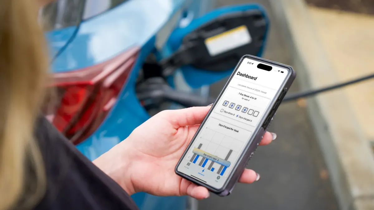 Egy használó nézi a Toyota ChargeMinder alkalmazást az okostelefonján.