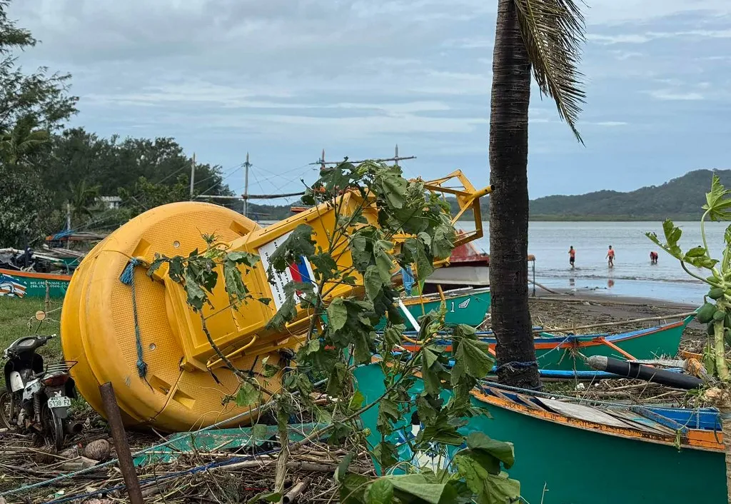 A navigational buoy is washed ashore at the height of Super Typhoon Ragasa in Santa Ana town, Cagayan province, north of Manila on September 23, 2025, a day after Typhoon Ragasa made landfall in the province. Ragasa had already toppled trees, tore the roofs off buildings and killed at least one person in a landslide while lashing the northern Philippines, where thousands sought shelter in schools and evacuation centres. (Photo by John Dimain / AFP)