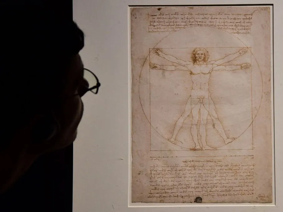da Vinci A visitor looks at the Leonardo's piece "Vitruvian Man" presented at the Palazzo Reale museum as part of the exhibition "Leonardo Da Vinci" on May 13, 2015 in Milan. The exhibition will run from May 15, 2015 to July 19, 2015. AFP PHOTO / GIUSEPPE CACACE (Photo by GIUSEPPE CACACE / AFP)
