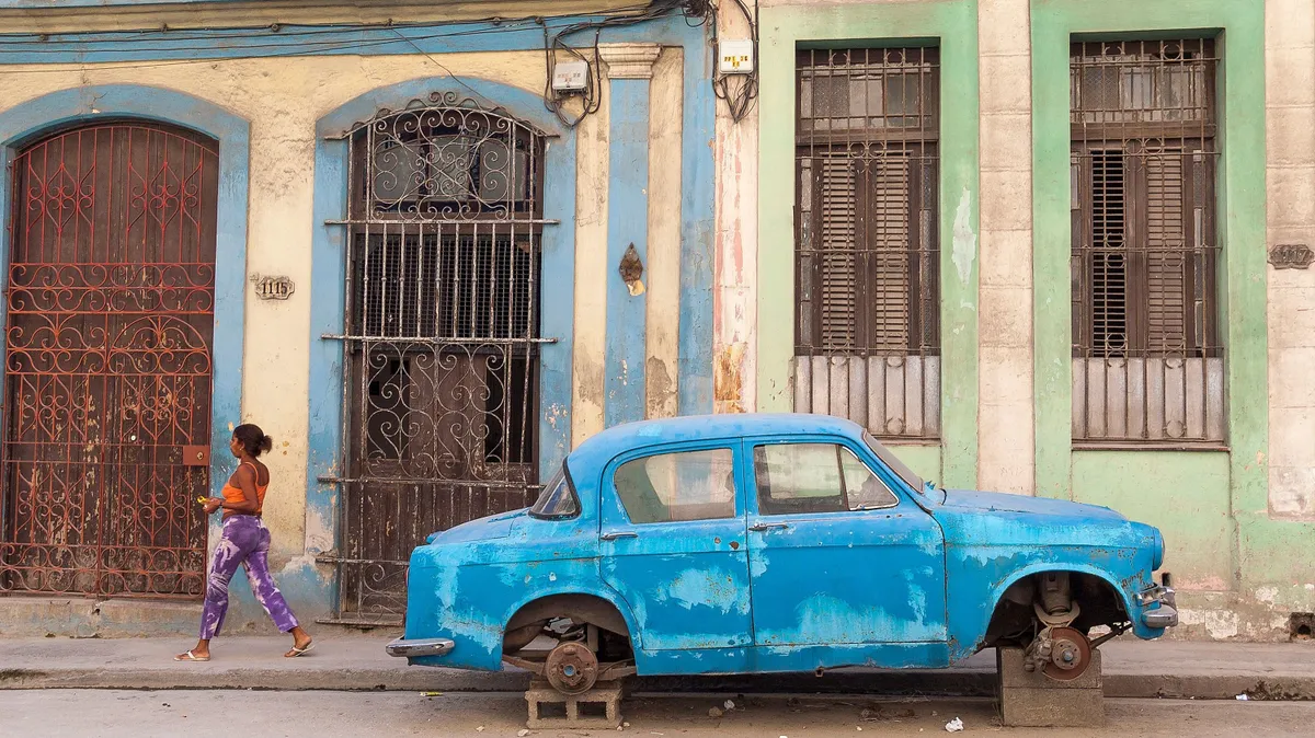 Broken down old car without its wheels resting on bricks in a back street, Havana, Cuba. (Photo by: Alex Segre/UCG/Universal Images Group via Getty Images)