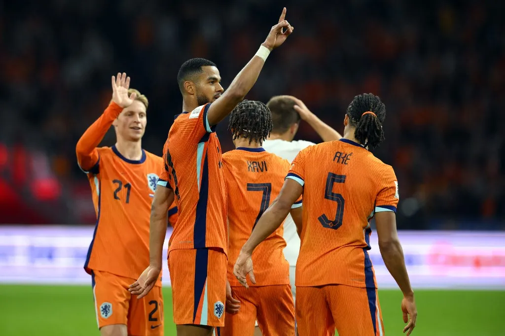 Netherlands' forward #11 Cody Gakpo (2L) celebrates with teammates after scoring his team's fourth goal during the FIFA World Cup 2026 Group G qualification football match between Netherlands and Finland, at the Johan Cruyff Arena in Amsterdam, on October 12, 2025. (Photo by JOHN THYS / AFP)
