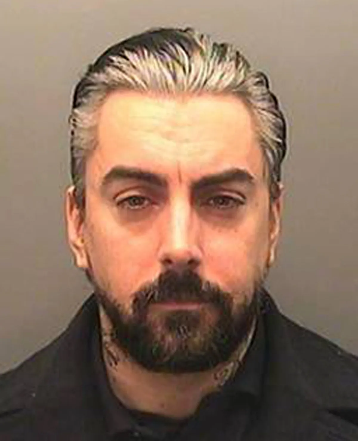 A handout picture released by South Wales Police on December 17, 2013 shows a portrait of British rock singer Ian Watkins who pleaded guilty on November 26, 2013 to the attempted rape of a baby and a string of other child sex offences. West Yorkshire police said former Lostprophets singer Ian Watkins died in prison on October 11, 2025. He was jailed on December 18, 2013 for 35 years at Cardiff Crown Court for a string of child sex offences including the attempted rape of a baby. (Photo by SOUTH WALES POLICE / AFP)