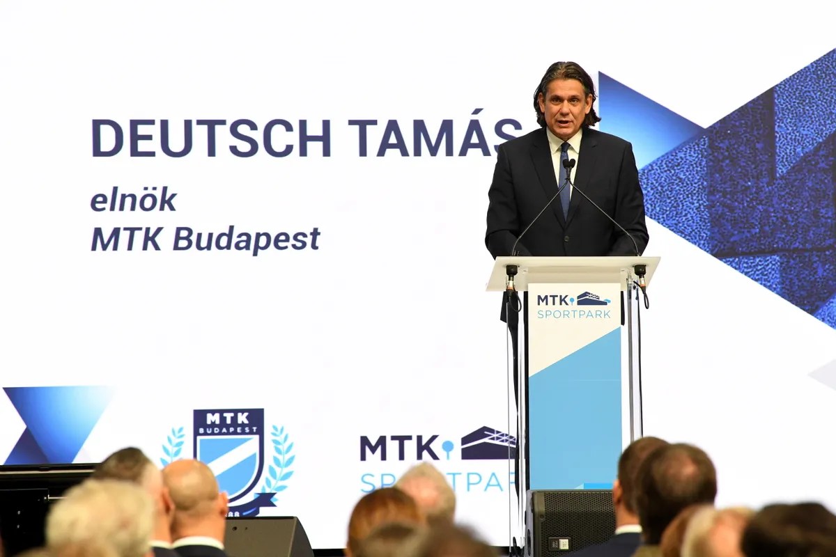 Budapest, 2025. szeptember 28.
Deutsch Tamás, az MTK elnöke beszédet mond az MTK Sportpark ünnepélyes megnyitóján Budapesten, a VIII. Kerepesi úton 2025. szeptember 28-án. A 9,5 hektáros sportpark területén többek között egy 5000 fős nézőtérrel rendelkező, több mint 11 ezer négyzetméteres sportcsarnok, egy 3800 négyzetméteres edzőcsarnok, 33 800 négyzetméteres zöldterület és egy hatalmas napelempark jött létre, a fűtést pedig az 1350 méter mélyről jövő geotermikus energia biztosítja.
MTI/Kovács Attila