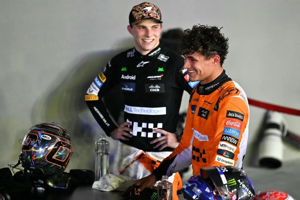 McLaren's British driver Lando Norris (R) celebrates after winning, with third place teammate McLaren's Australian driver Oscar Piastri (L), at the Formula One Singapore Grand Prix night race at the Marina Bay Street Circuit in Singapore on September 22, 2024. (Photo by MOHD RASFAN / AFP)