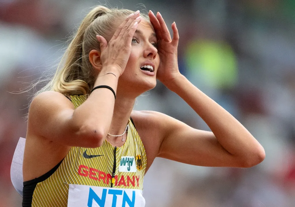 19 August 2023, Hungary, Budapest: Athletics: World Championship, 4 x 400 m, Mixed, Preliminary heat, at the National Athletics Center. Alica Schmidt from Germany reacts at the finish line. Photo: Sven Hoppe/dpa (Photo by SVEN HOPPE / dpa Picture-Alliance via AFP)