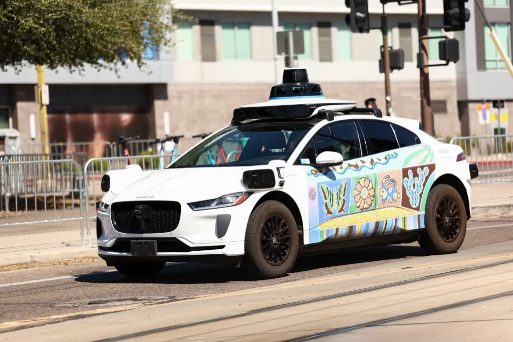 A Waymo autonomous self-driving Jaguar electric vehicle is seen in Tempe, Arizona, on the outskirts of Phoenix, on September 15, 2025. (Photo by CHARLY TRIBALLEAU / AFP), taxi