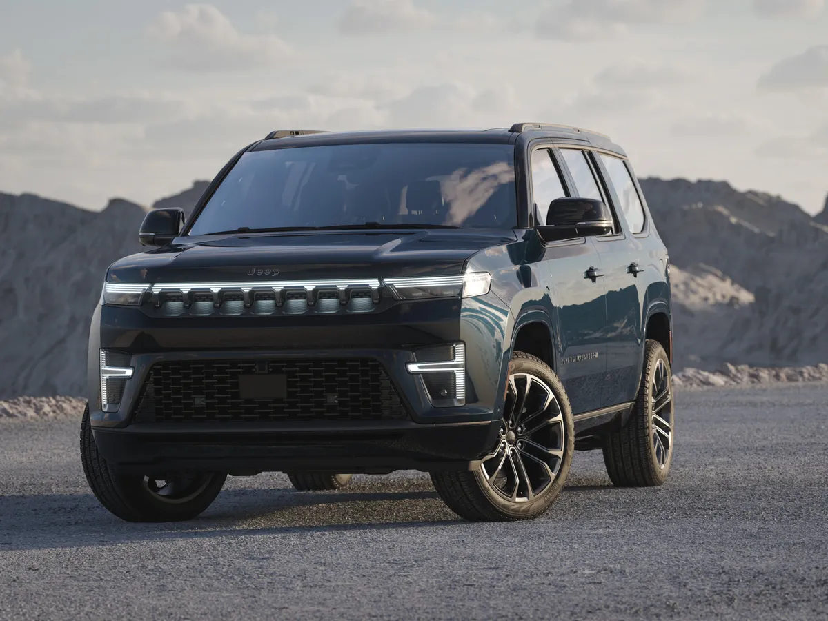 Egy Jeep Grand Wagoneer áll hegyvidéki táj előtt.