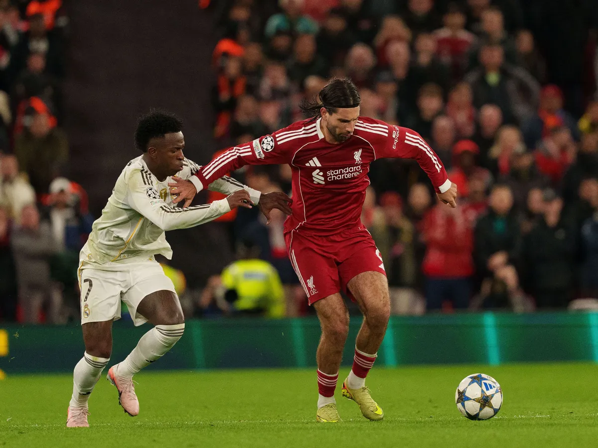 Dominik Szoboszlai of Liverpool battles with Vinicius Junior of Real Madrid during the UEFA Champions League match between Liverpool and Real Madrid at Anfield in Liverpool, England, on November 4, 2025. (Photo by Steven Halliwell/MI News/NurPhoto) (Photo by MI News / NurPhoto via AFP)