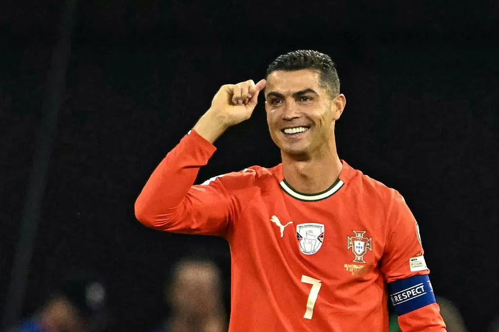 Portugal's forward #07 Cristiano Ronaldo (R) celebrates after scoring the 1-2 penalty goal as Hungary's midfielder #17 Callum Styles reacts during the 2026 World Cup qualifiers Europe zone group F football match between Hungary and Portugal on September 9, 2025 in Budapest, Hungary. (Photo by Attila KISBENEDEK / AFP)