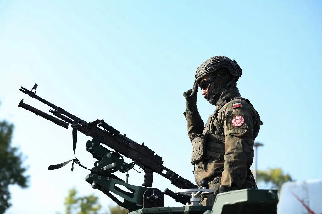 A soldier participates in the official celebrations of the 6th Airborne Brigade Day at the Polish Aviation Museum in Krakow, Poland, on October 3, 2025. On the occasion of the 6th Airborne Brigade Day, named after Brigadier General Stanislaw Sosabowski, a ceremonial assembly takes place at the Polish Aviation Museum. During the event, decorations are awarded, followed by a parade featuring a parachute jump demonstration. The celebration also includes stands prepared by various uniformed services for participants. (Photo by Klaudia Radecka/NurPhoto) (Photo by Klaudia Radecka / NurPhoto via AFP)