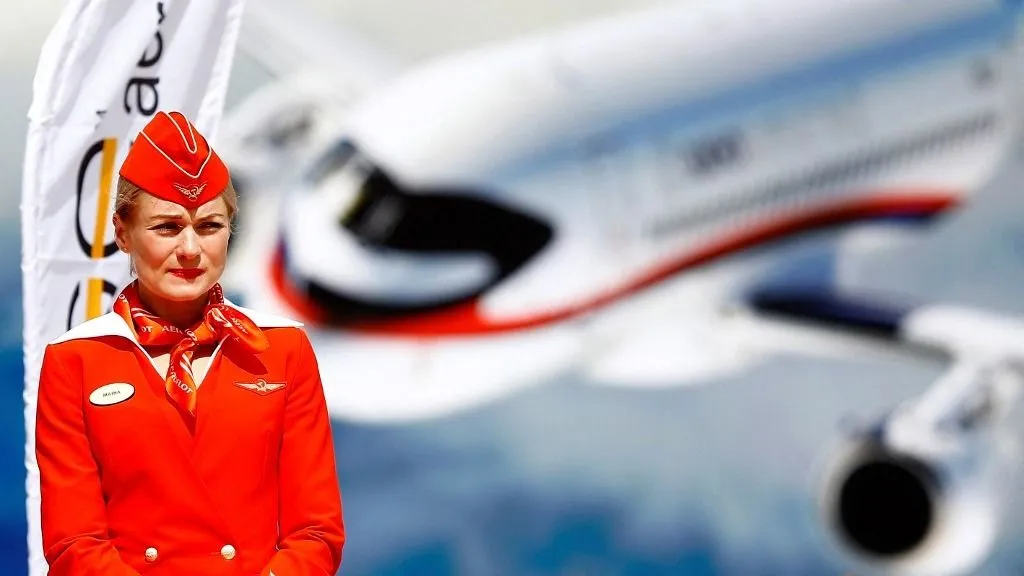 MOSCOW, RUSSIA - JULY 19 : An Aeroflot flight attendant is seen near a Sukhoi Superjet 100 (SSJ-100) passenger aircraft on display at the MAKS-2017 International Aviation and Space Salon in Zhukovsky, Moscow Region, Russia, on July 19, 2017. Sefa Karacan / Anadolu Agency (Photo by SEFA KARACAN / ANADOLU AGENCY / Anadolu via AFP)