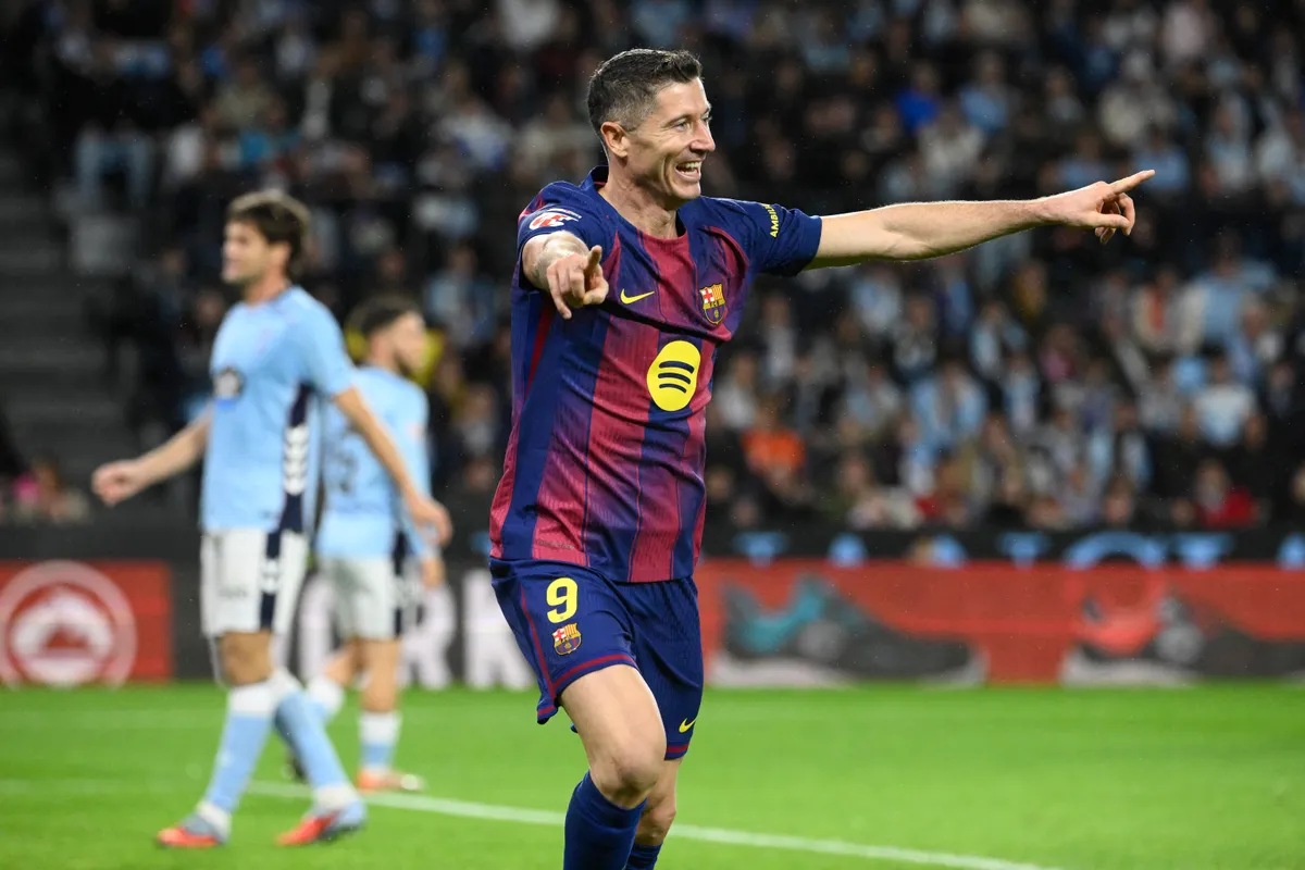 Barcelona's Polish forward #09 Robert Lewandowski celebrates his second goal during the Spanish league football match between RC Celta de Vigo and FC Barcelona at Balaidos Stadium in Vigo on November 9, 2025. (Photo by Miguel RIOPA / AFP)